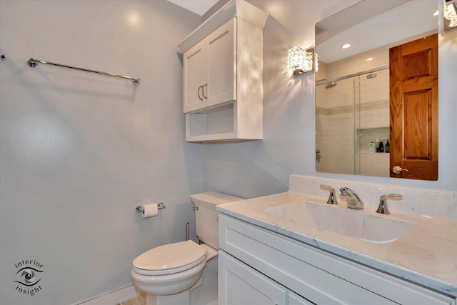 full bath featuring toilet, a shower stall, and vanity
