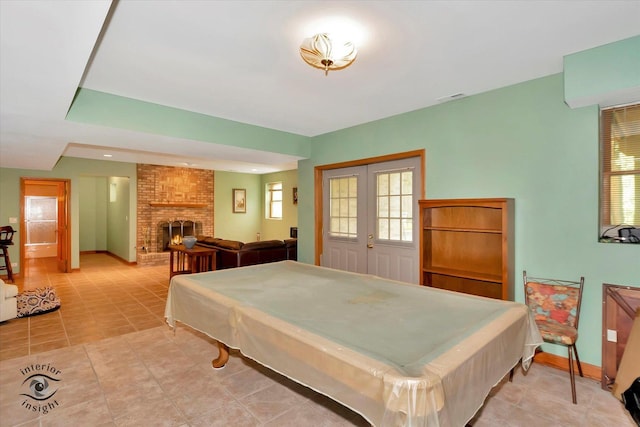 recreation room featuring a fireplace, pool table, baseboards, and light tile patterned floors