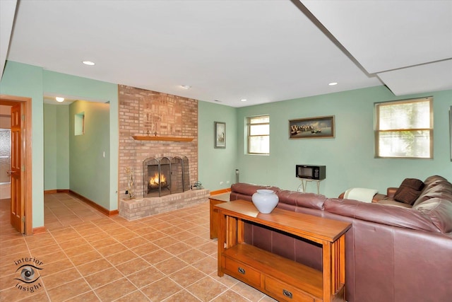 living room featuring light tile patterned flooring, a fireplace, and recessed lighting