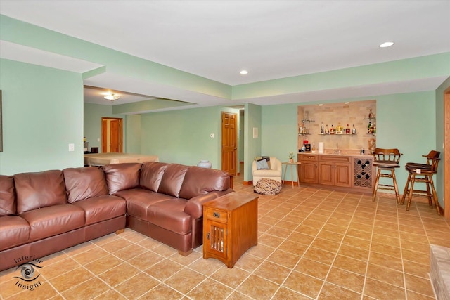 living area with bar area, light tile patterned floors, and recessed lighting