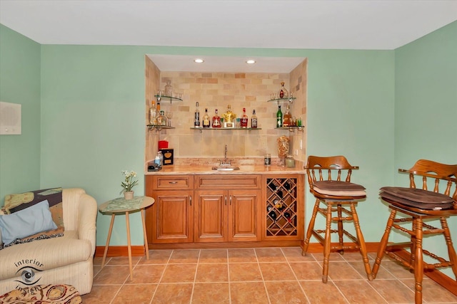 indoor wet bar with baseboards, light tile patterned floors, and recessed lighting