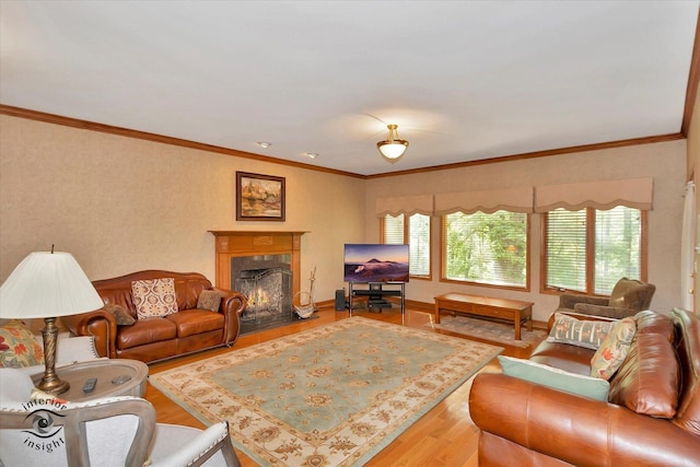 living room with wood finished floors, plenty of natural light, a fireplace, and ornamental molding