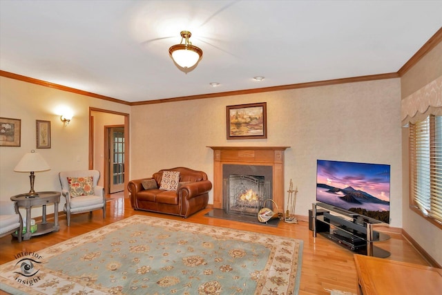 living room with wood finished floors, a premium fireplace, crown molding, and baseboards