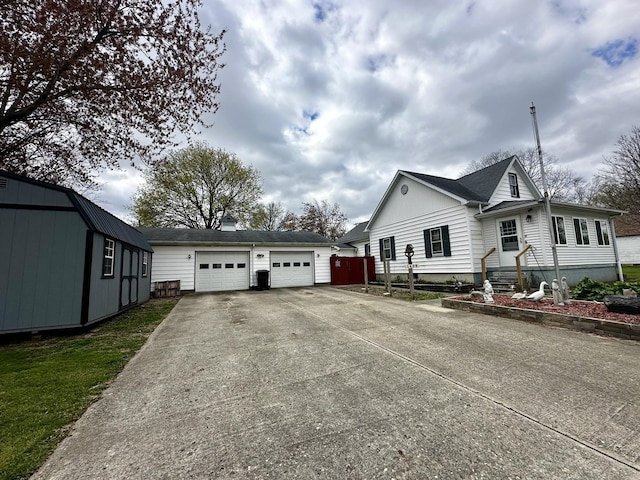 view of home's exterior featuring an attached garage and driveway