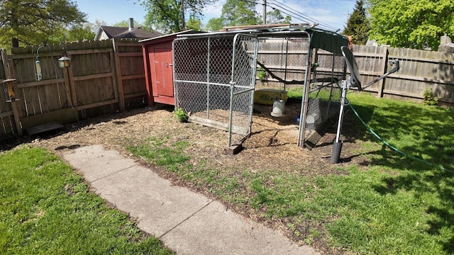 view of yard featuring a fenced backyard, exterior structure, and an outdoor structure