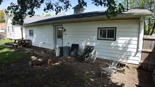 back of property featuring fence