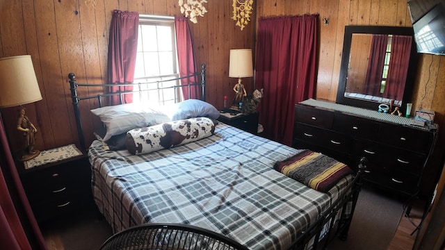bedroom featuring wooden walls