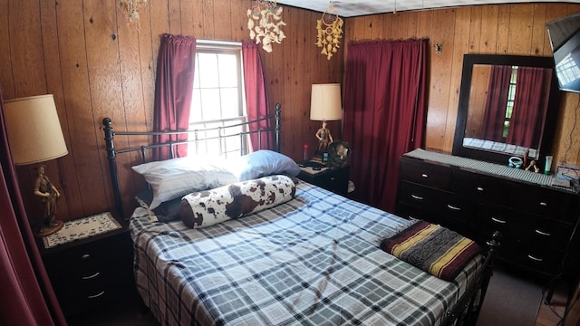 bedroom featuring wood walls
