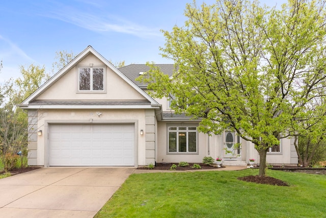 view of front facade with a front lawn, a shingled roof, stucco siding, and driveway