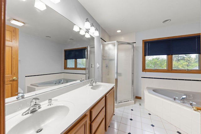 bathroom featuring a sink, tile patterned flooring, and a garden tub