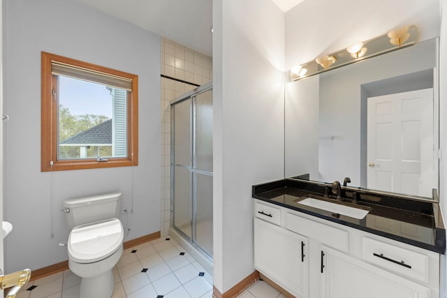 bathroom with a stall shower, baseboards, toilet, tile patterned floors, and vanity