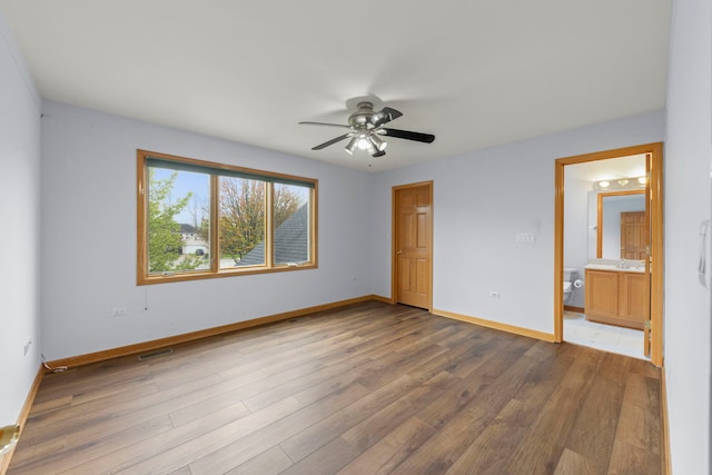 unfurnished bedroom with baseboards, visible vents, and wood finished floors