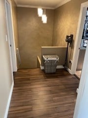 interior space with wood finished floors, baseboards, and ornamental molding
