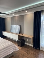bedroom with recessed lighting, wood finished floors, and multiple windows
