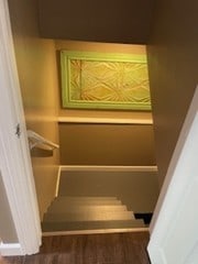 stairs featuring wood finished floors