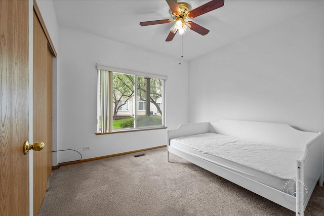 bedroom with carpet, baseboards, a closet, and a ceiling fan