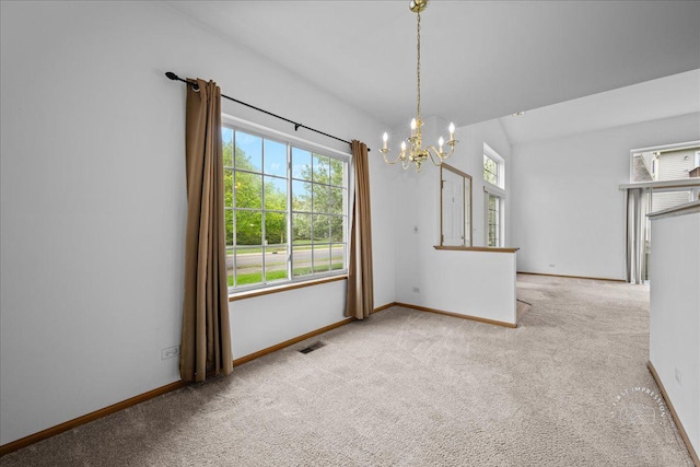 unfurnished dining area featuring a chandelier, carpet flooring, and baseboards