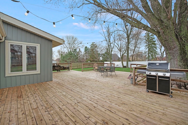 wooden deck featuring outdoor dining space and area for grilling