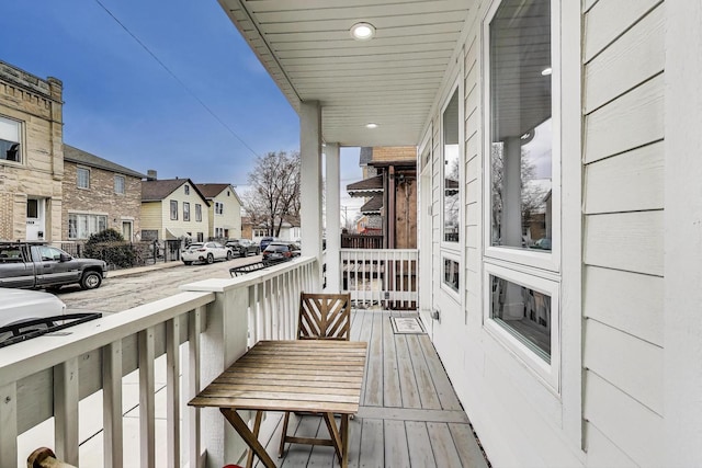 balcony with covered porch and a residential view