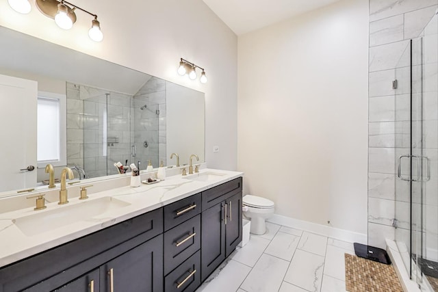 bathroom with a shower stall, double vanity, marble finish floor, and a sink