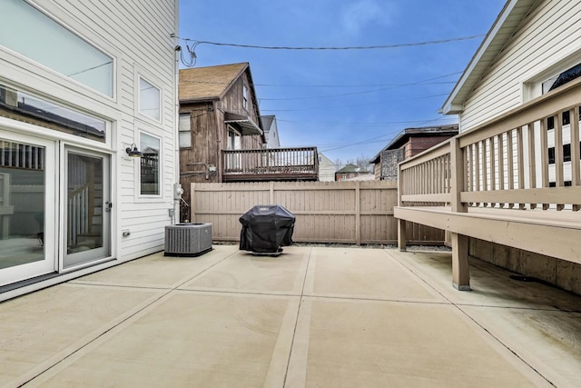 view of patio / terrace with grilling area, central AC unit, and fence