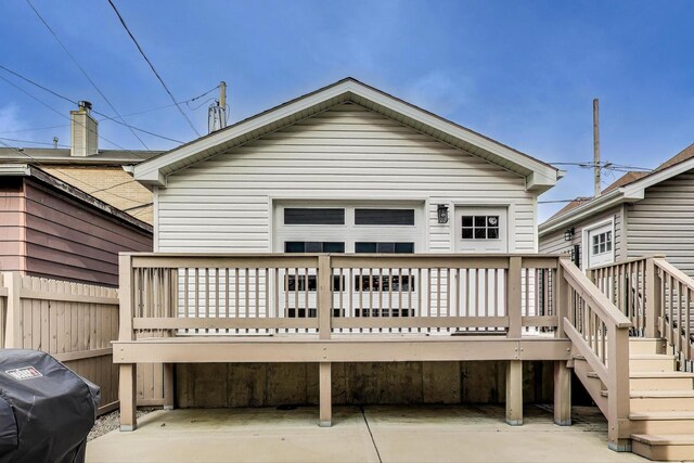 back of house with a wooden deck