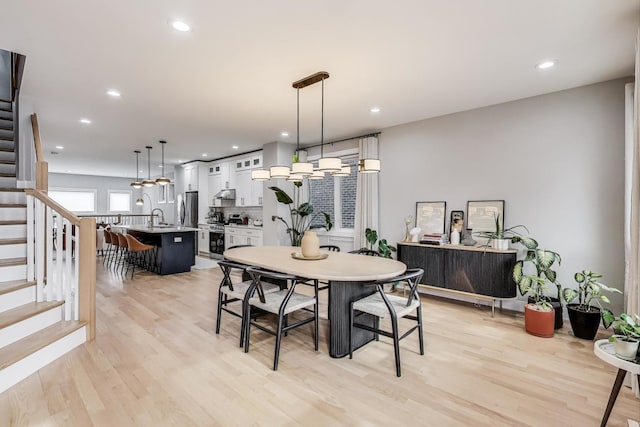dining area featuring recessed lighting, stairway, and light wood-style floors