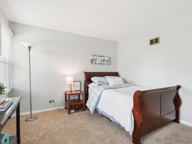 bedroom featuring light carpet, visible vents, and baseboards