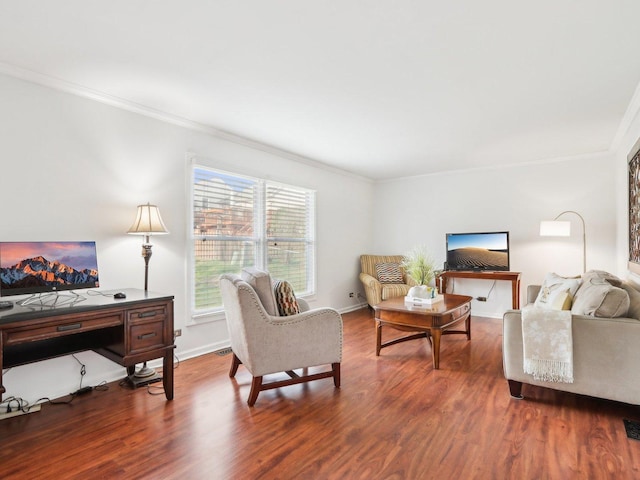 living area with baseboards, crown molding, and wood finished floors
