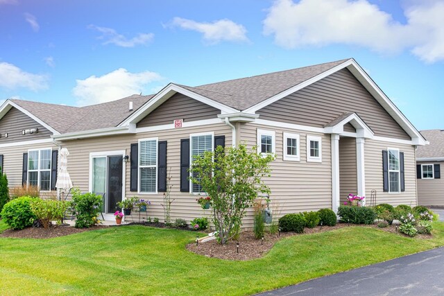 single story home with driveway, a front yard, and a garage