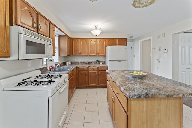2336 Union St Unit 3, Blue Island, IL 60406 - kitchen with white appliances, brown cabinetry, light tile patterned floors, a sink, and a center island