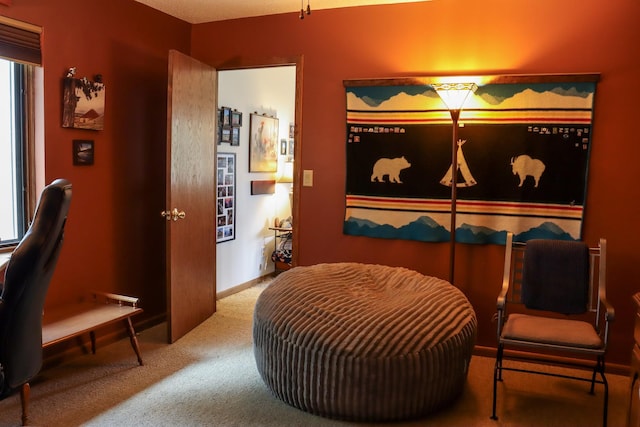 sitting room with baseboards and carpet
