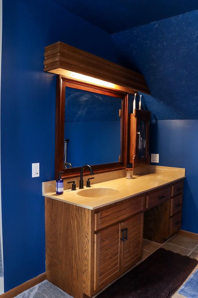 interior space with tile patterned floors, vanity, and baseboards