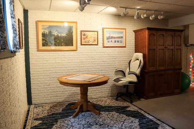 sitting room featuring rail lighting and a drop ceiling