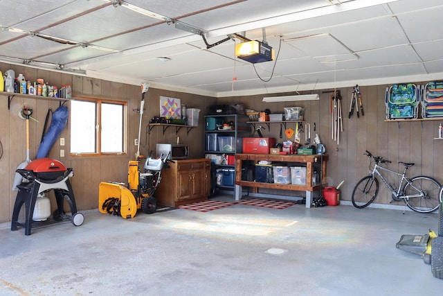garage featuring wooden walls and a garage door opener