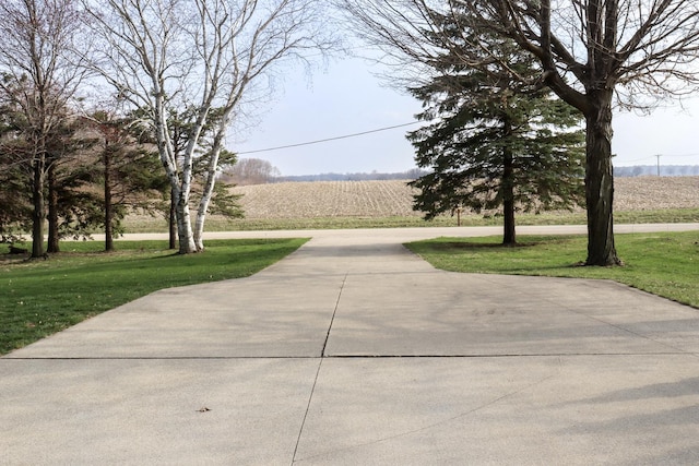 view of community featuring a rural view and a lawn
