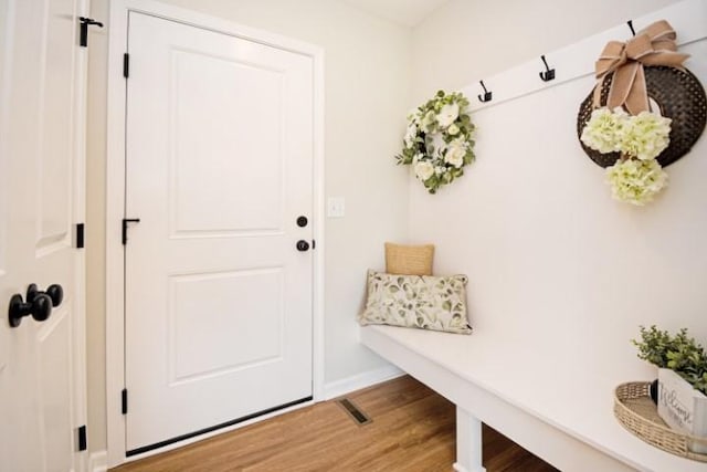 mudroom with baseboards and wood finished floors