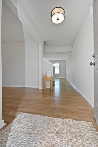 interior space with baseboards and wood finished floors