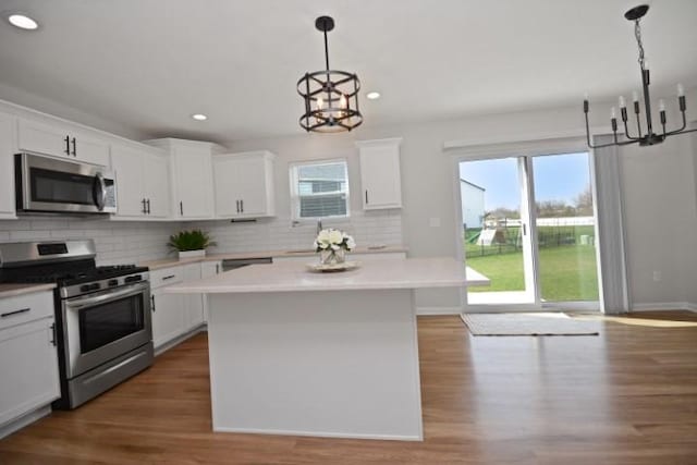 kitchen featuring an inviting chandelier, appliances with stainless steel finishes, and plenty of natural light