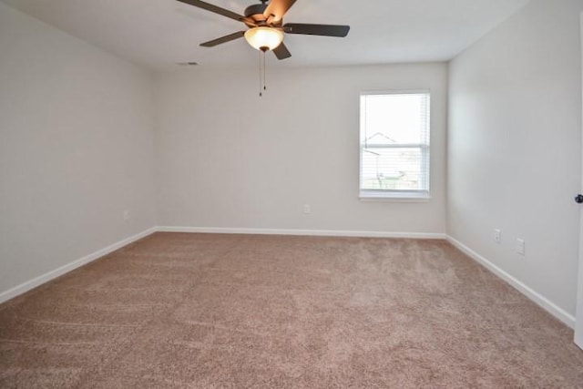 spare room featuring baseboards, carpet flooring, and ceiling fan
