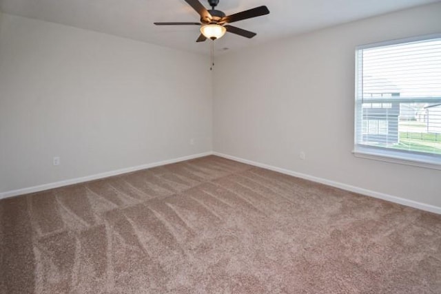unfurnished room with ceiling fan, carpet floors, and baseboards