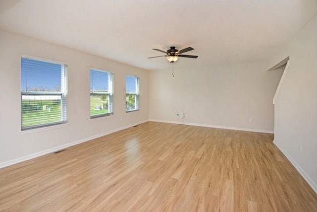 unfurnished room featuring baseboards, a ceiling fan, and light wood-type flooring