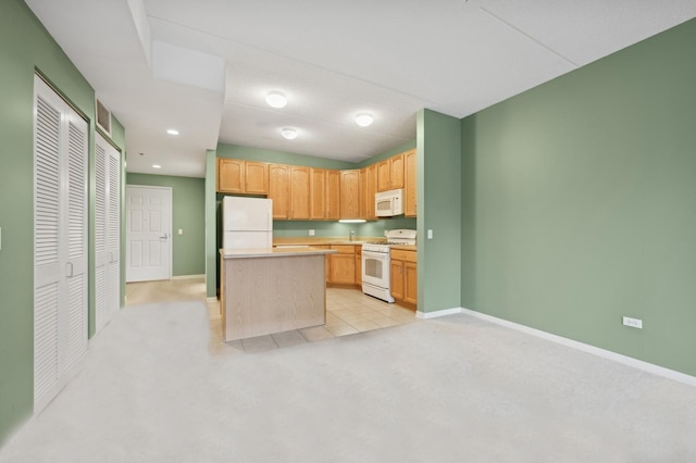 2335 W Belle Plaine Ave Unit 207, Chicago, IL 60618 - kitchen with white appliances, light colored carpet, baseboards, light countertops, and a kitchen island
