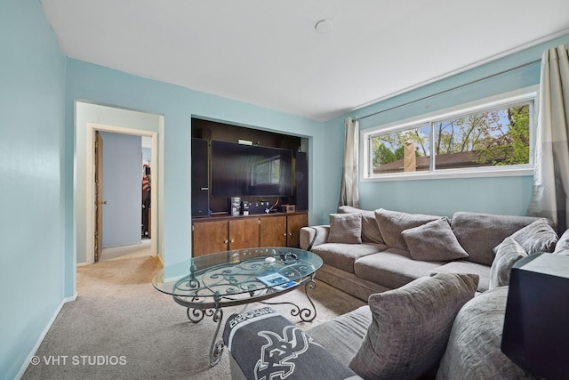 living area with light colored carpet and baseboards
