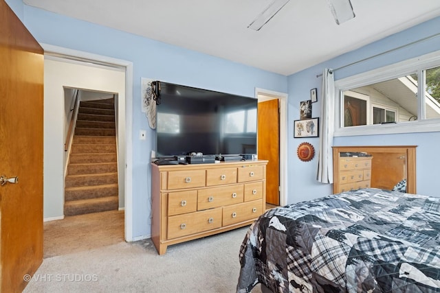 bedroom featuring baseboards and light carpet