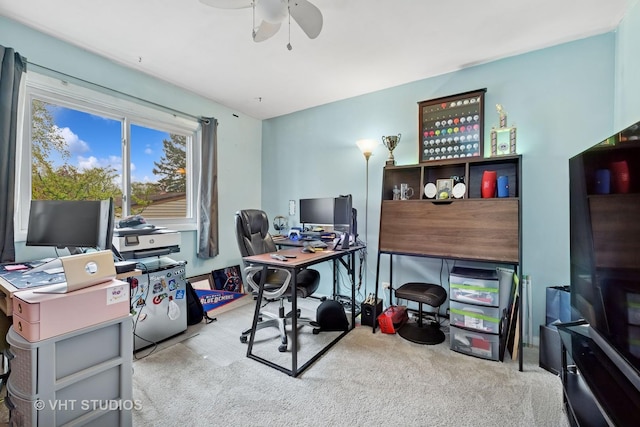 carpeted office space featuring ceiling fan