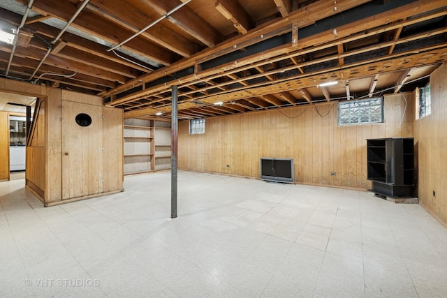 below grade area with wood walls and light floors