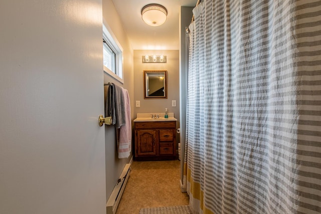112 E Peru St, Princeton, IL 61356 - full bathroom featuring baseboard heating, vanity, and a shower with curtain