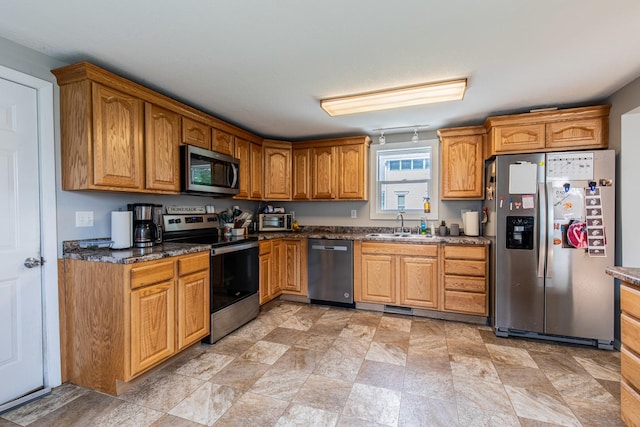 112 E Peru St, Princeton, IL 61356 - kitchen featuring stainless steel appliances, stone finish floors, brown cabinets, and dark stone counters
