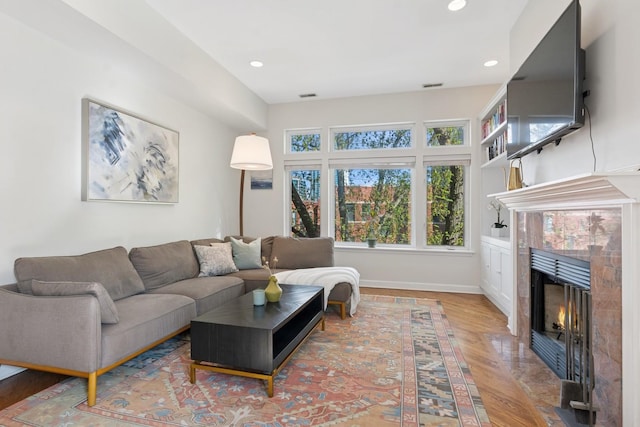 625 W Patterson Ave Unit 3E, Chicago, IL 60613 - living area featuring a high end fireplace, wood finished floors, recessed lighting, and baseboards